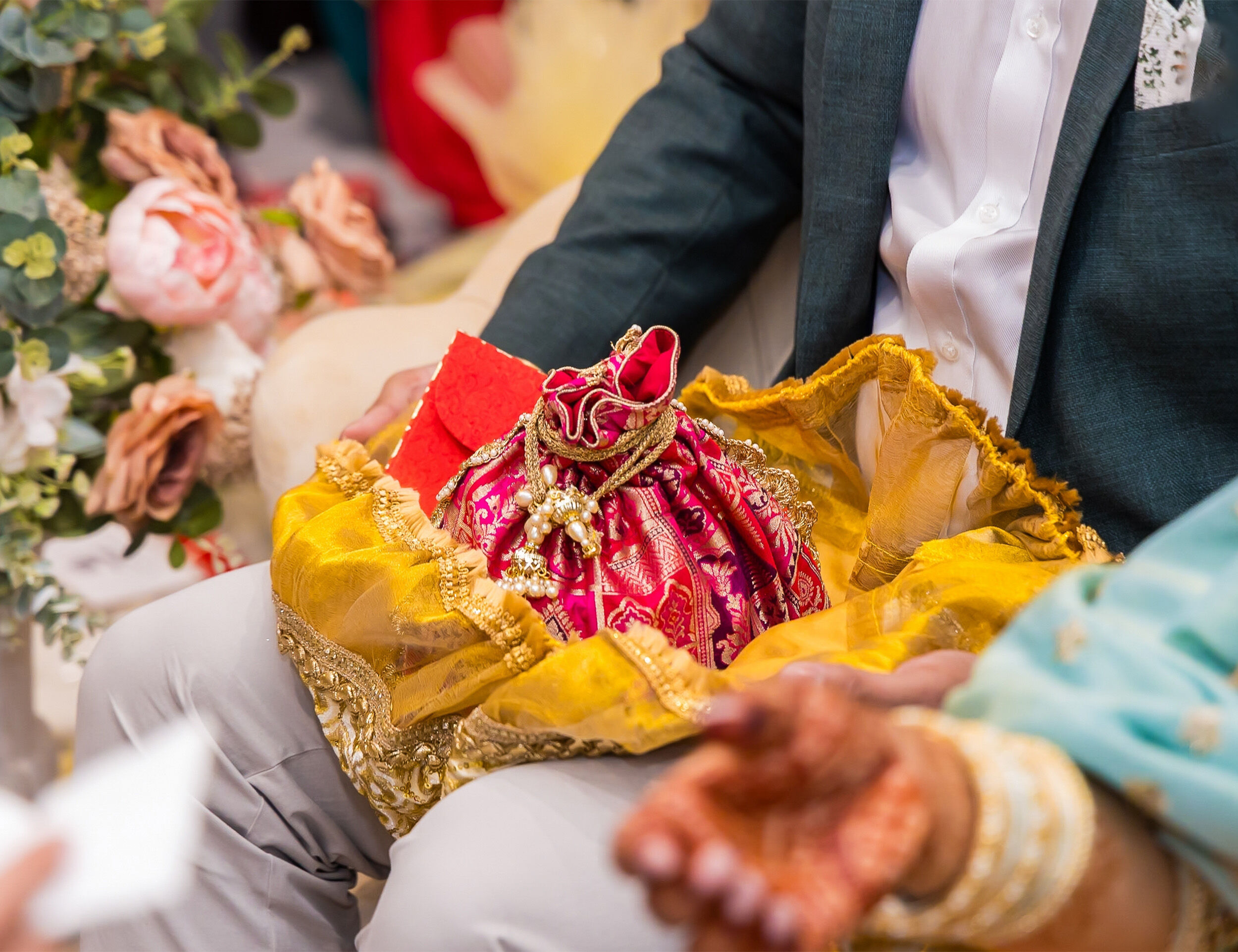 Red potli bag filled with beautiful bridal gifts.